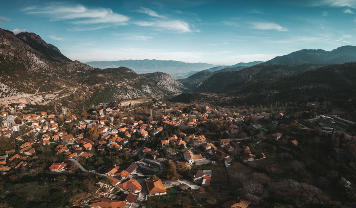 aerial photography of village surrounded by mountains
